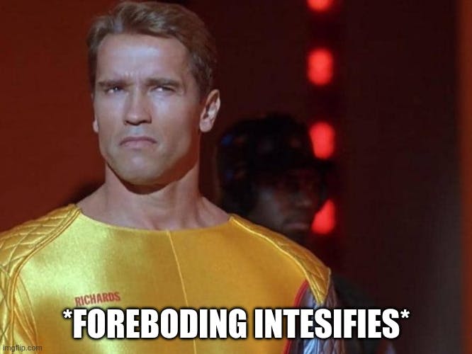 Arnold Schwarzenegger looking skeptical in a movie still of "Running Man"