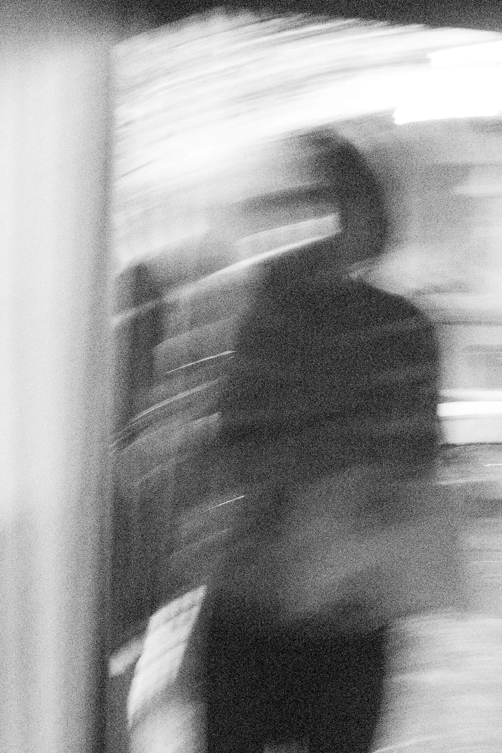 A blurry photo of a woman in a doorway