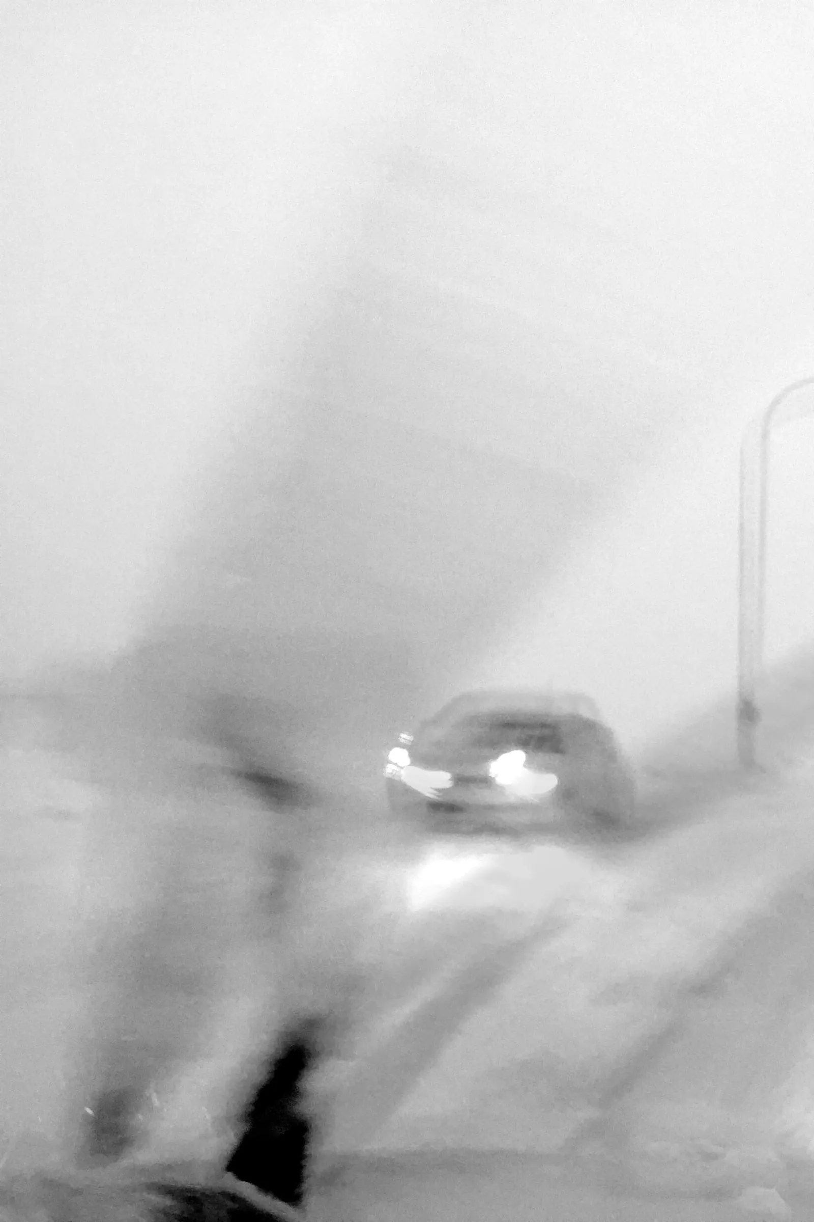 A blurry photo of cars driving through a snow storm