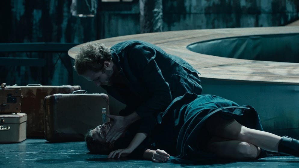 Nora Nielsen (Giulia Goldammer) auf der Bühne in der Rolle der Nina ist mitten im Auftritt zusammengebrochen. Carl Silberman (Lukas T. Sperber) versucht zu ihr helfen // Bild: BR/Claussen+Putz Filmproduktion GmbH/Johann Feindt