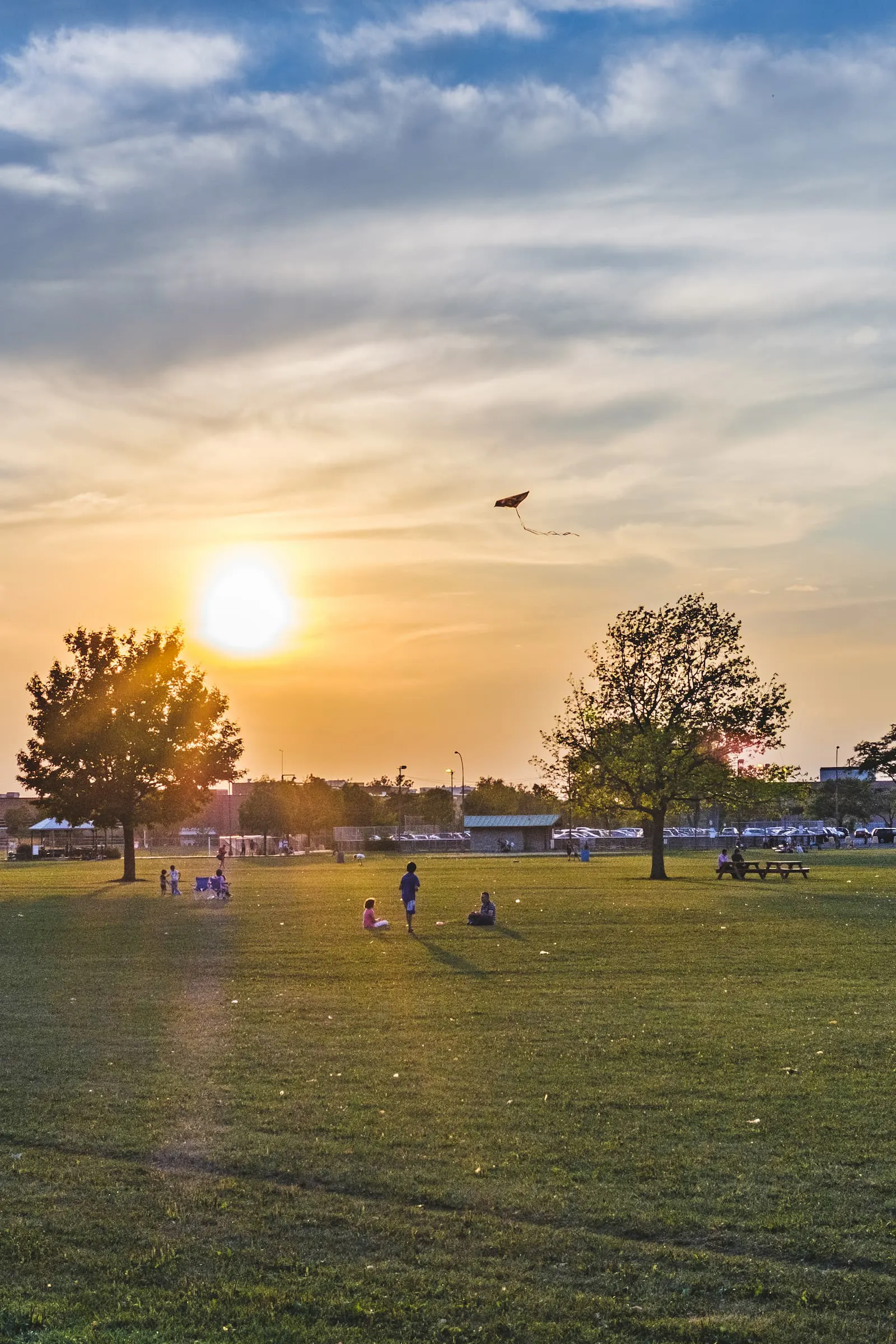 Children play with a kite in Parc Jarry