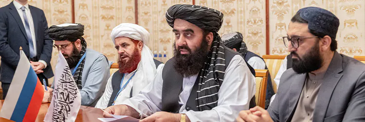 Mehrere Taliban an einem Verhandlungstisch.