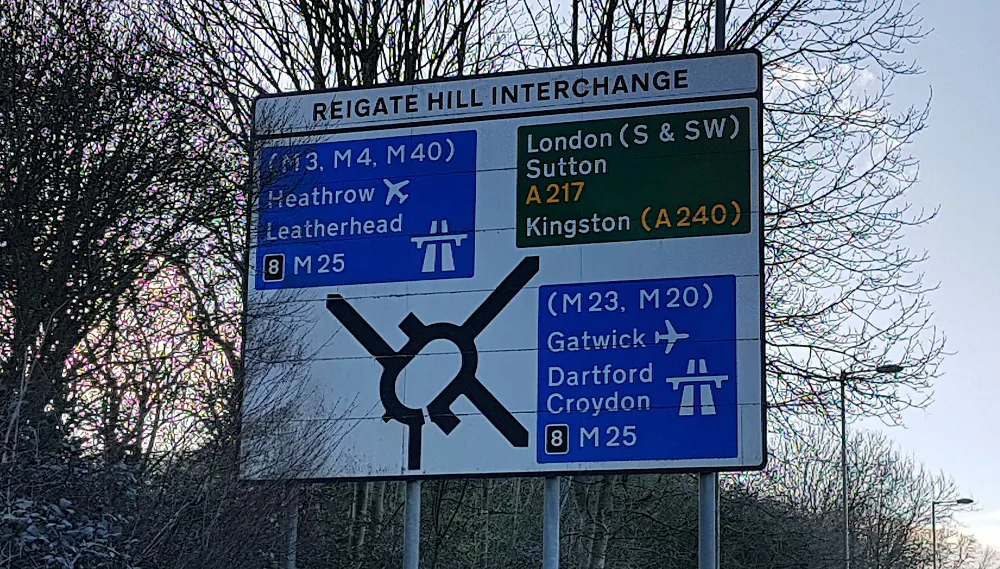 Reigate Hill (A217) road sign showing roundabout and exits