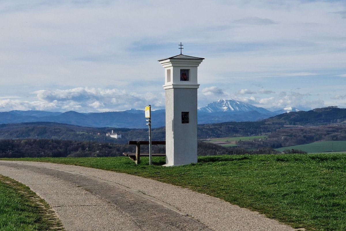 Marterl, im Hintergrund die schneebdeckten Berge der Voralpen