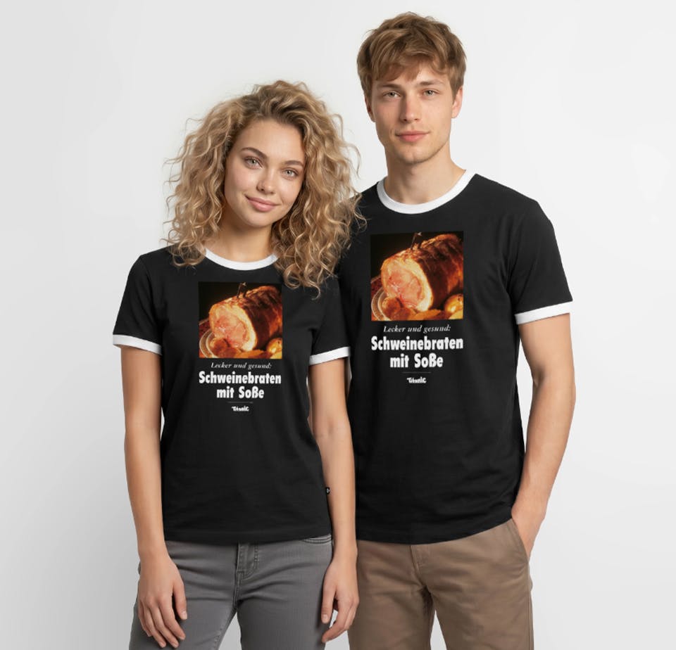 Ein Mann und eine Frau. Beide tragen eine schwarze T-Shirts. Die T-Shirts sind mit einem Schweinebraten bedruckt unter dem folgender Text steht: 
Lecker und Gesund: Schweinebraten mit Soße