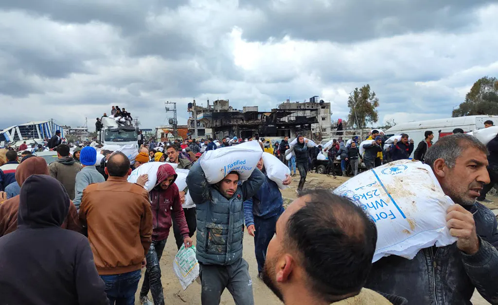 Palästinenser tragen Hilfslieferungen