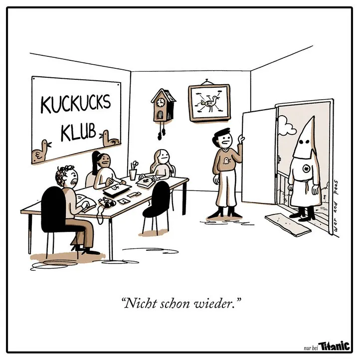 Drei Menschen sitzen an einem Tisch, an der Wand hängen eine Kuckucksuhr und ein Poster, auf dem ein Kuckuck abgebildet ist. Auf einem großen Schild steht "Kuckucksklub". Eine Person, die einen Pullover mit Kuckucksmotiv trägt, öffnet die Tür, vor der jemand in Ku-Klux-Klan-Montur steht. Die Person, die die Tür öffnet, sagt: "Nicht schon wieder."