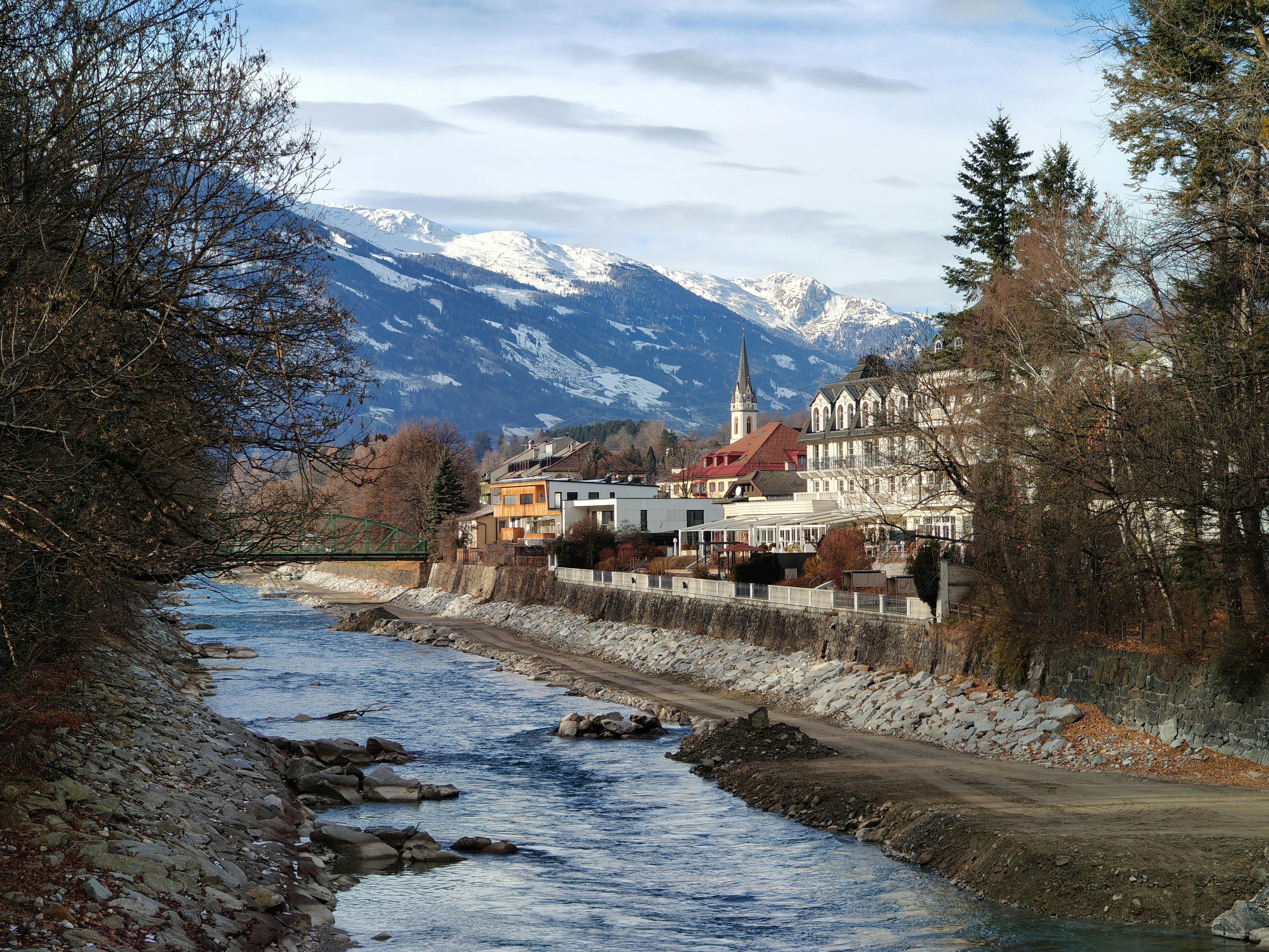 Lienz as a riverside town framed by the Isel river, a church steeple and snowcapped mountains | Bahnhofsplatz 11, 9900 Lienz