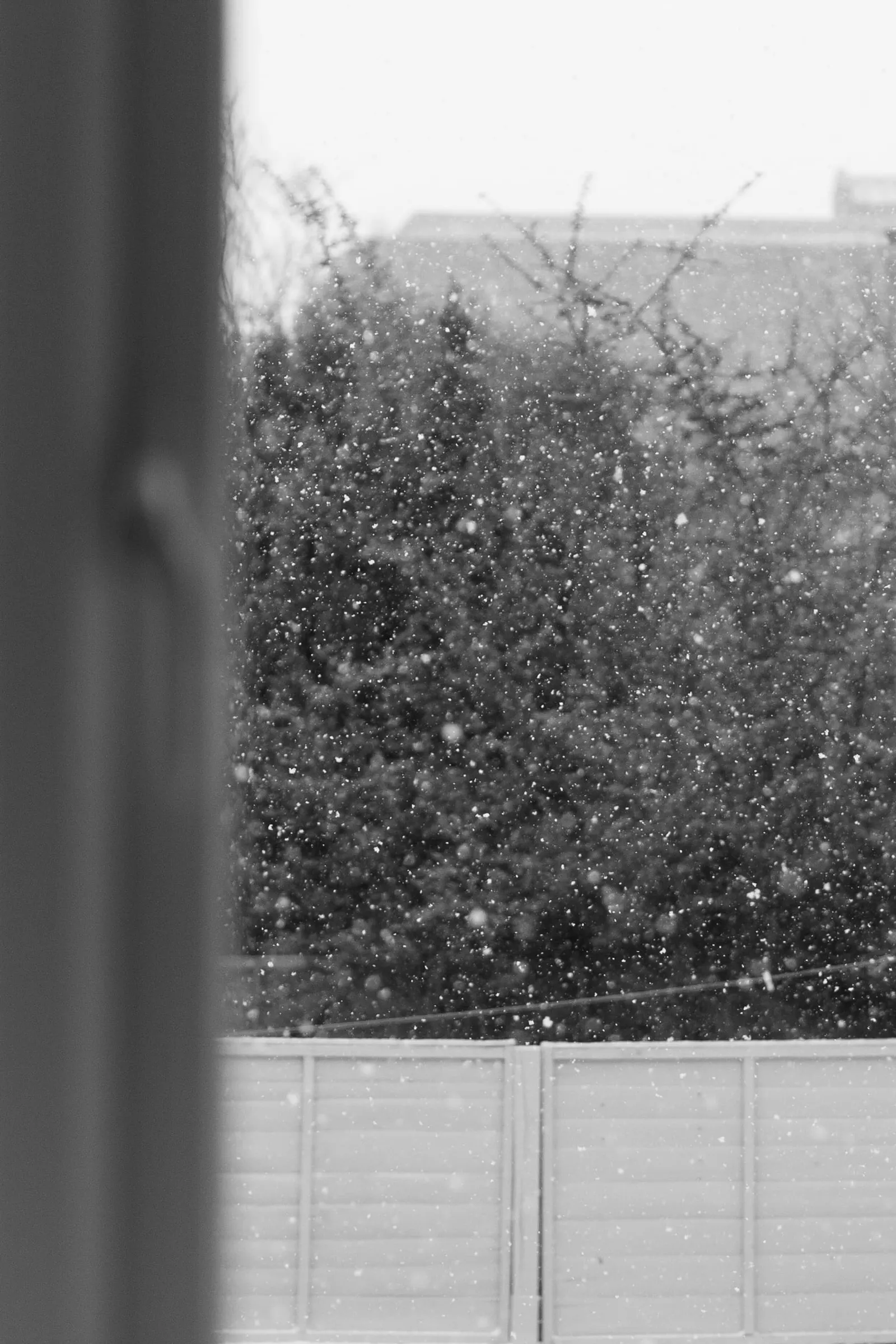 A look out of a window. Outside it is snowing