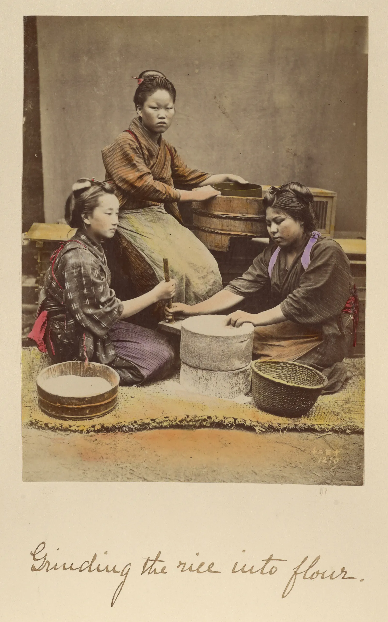 Shinichi Suzuki (Japanese, 1835 - 1919), photographer
Grinding the rice into flour, about 1873–1883
Hand-colored albumen silver print
Image: 17.2 × 12.7 cm (6 3/4 × 5 in.)
The J. Paul Getty Museum, Los Angeles, 84.XA.765.8.64