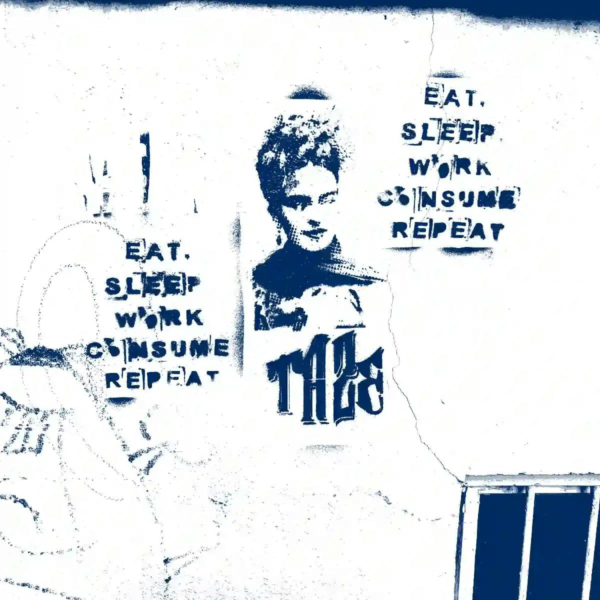 Ein Graffitti mit der Aufschrift "Eat, Sleep, Work, Consume, Repeat".