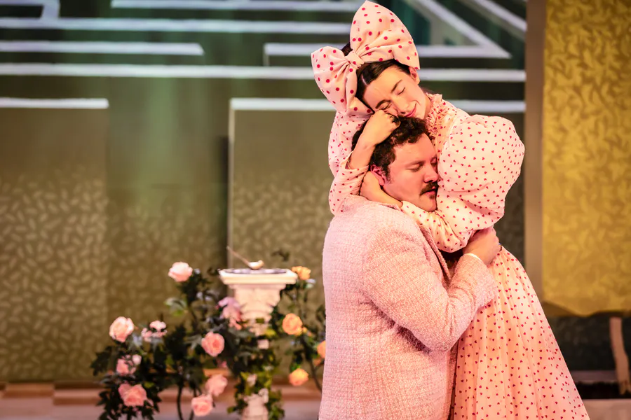 Image shows actors Conor O'Donnell as Algernon and Calla Hughes Nic Aoidh as Cecily in a scene from The Importance of Being Earnest