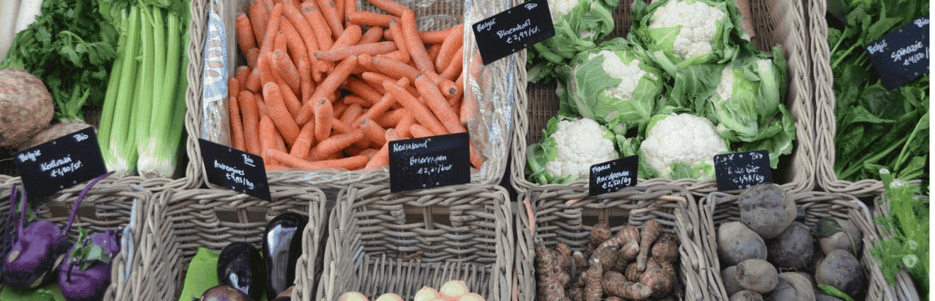 Gemüsestand auf einem Markt mit Gemüse in Körben
