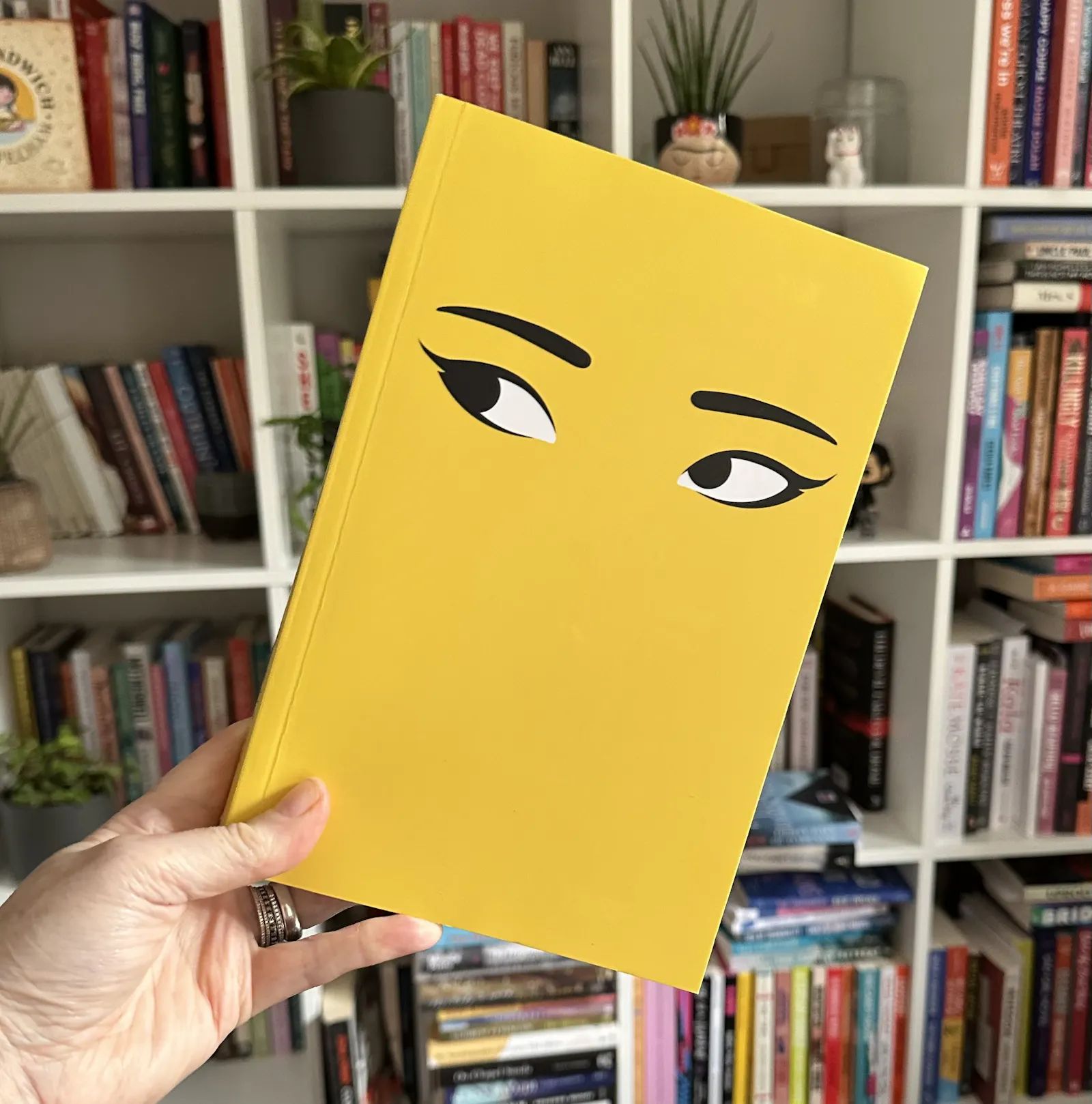 yellow book cover with a pair of eyes