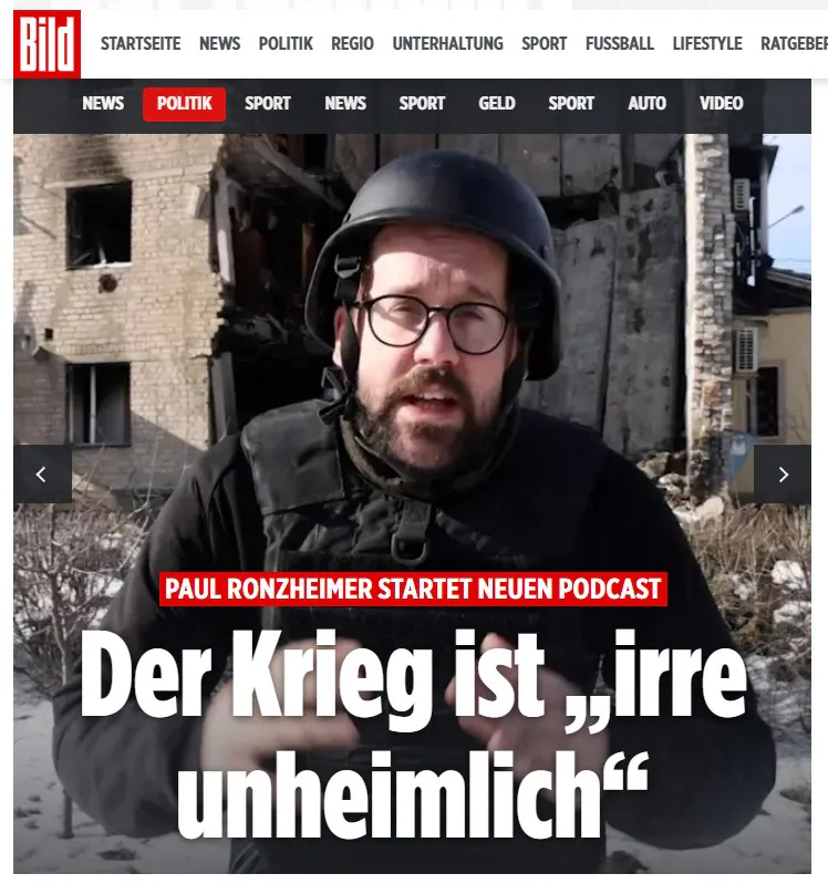 Screenshot bild.de, Paul Ronzheimer in Schutzkleidung vor einem offenbar zerbomten Haus, dazu die Schlagzeilen:
PAUL RONZHEIMER STARTET NEUEN PODCAST. Der Krieg ist „irre unheimlich“.