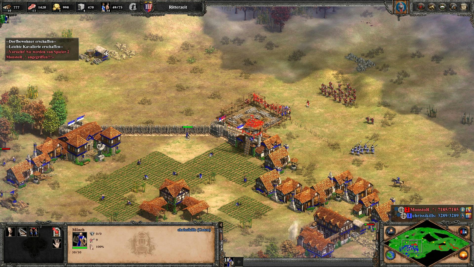Screenshot Age of Empires, ein kleines eingemauertes Dorf, davor wird eine Burg errichtet