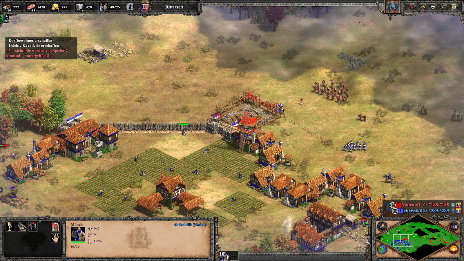 Screenshot Age of Empires, ein kleines eingemauertes Dorf, davor wird eine Burg errichtet