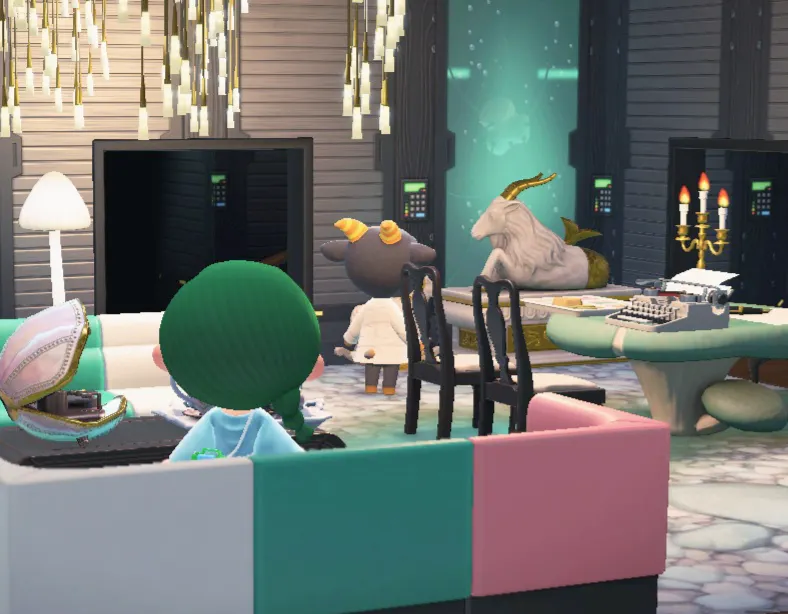 Screenshot aus dem Switch-Spiel "Animal Crossing", menschliche Spielfigur von Christiane Frohmann sieht der Villagerin Nan – eine Ziege – dabei zu, wie sie eine Steinbock-Statue ansieht.