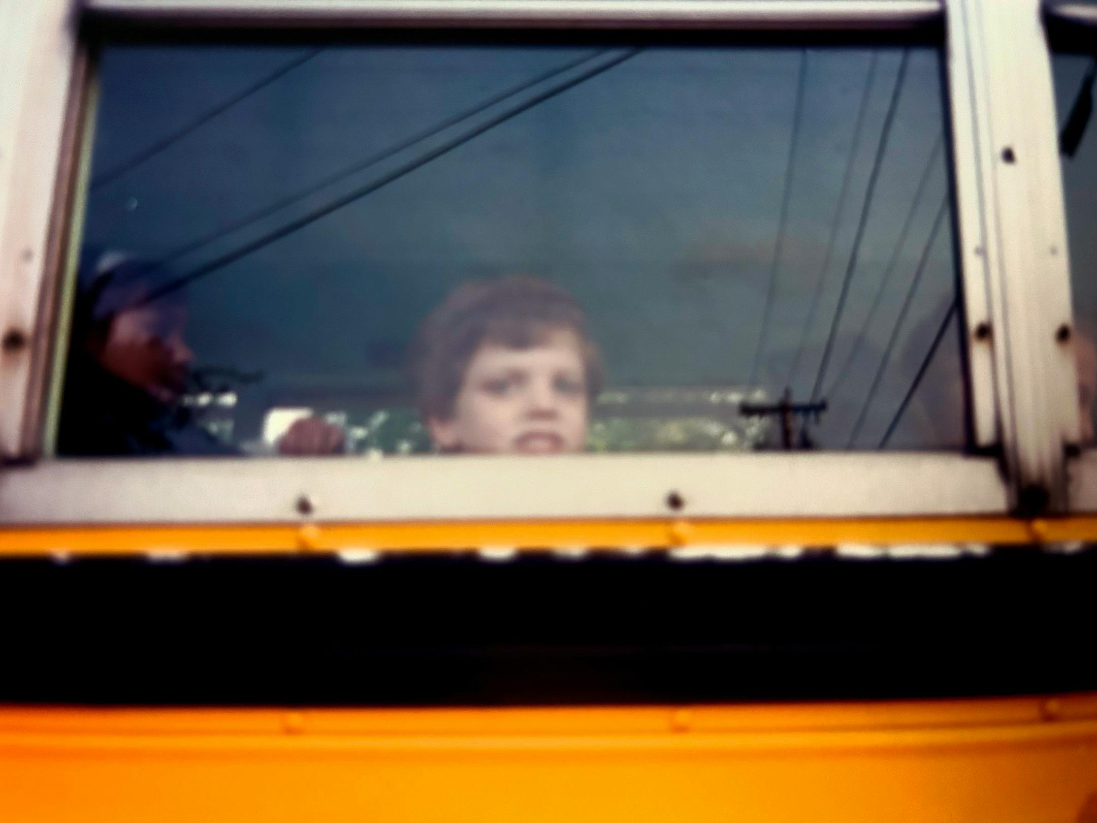 A terrified young Mike on the bus, off to the first grade looking out of the window as though it would be the last time he saw his mother, grandmother, and sister.