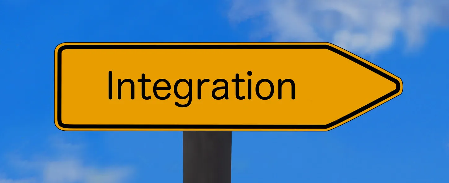 Das Bild zeigt ein gelbes Straßenschild mit schwarzer Schrift, einem Pfeil nach rechts und der Aufschrift „Integration“.