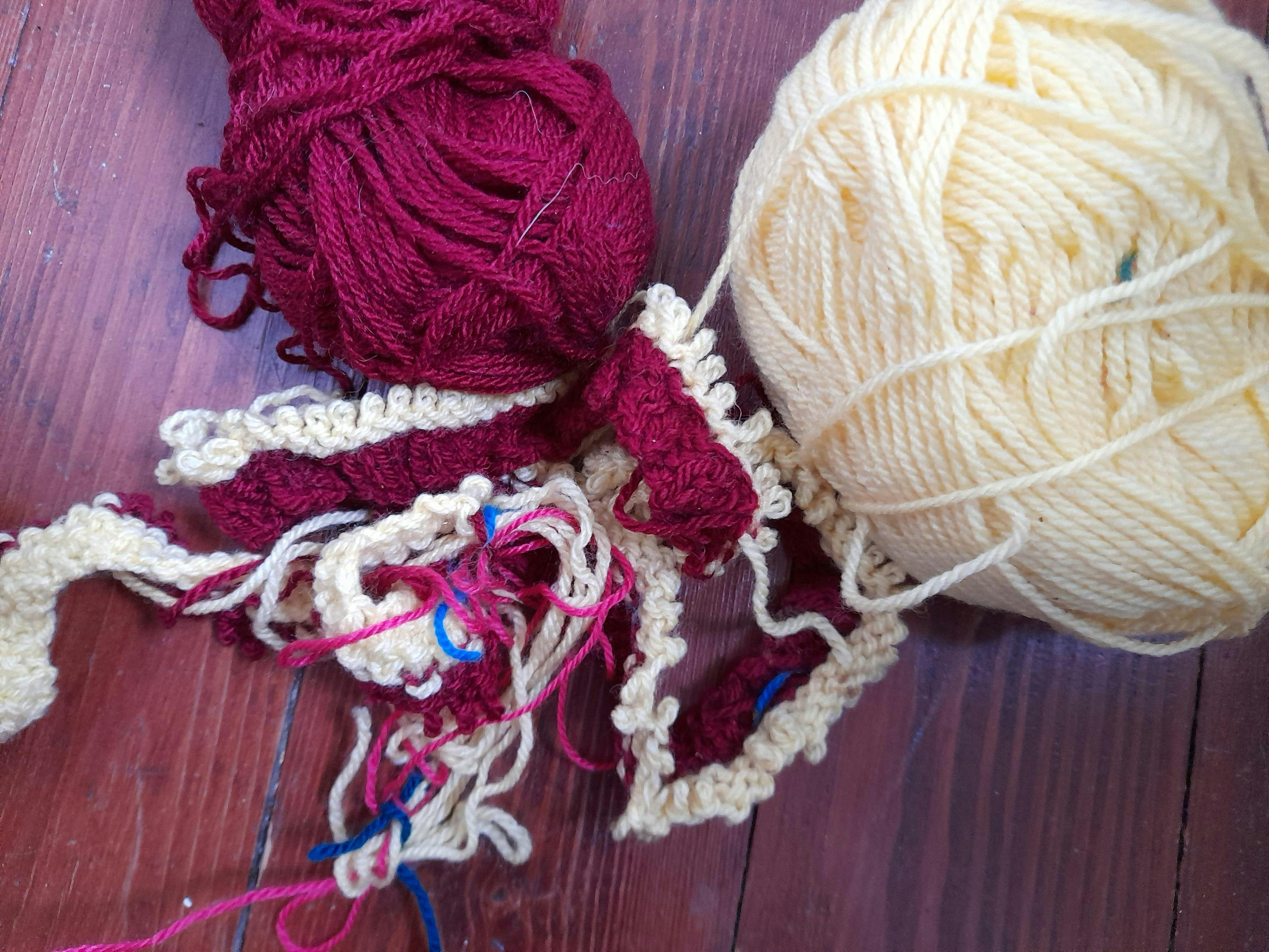 Chaos of red and yellow wool, some pink thread and the beginning of knitting something. Thrown away after some rows only.