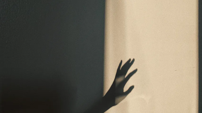 Light and shadow, a a hand reaching towards the light